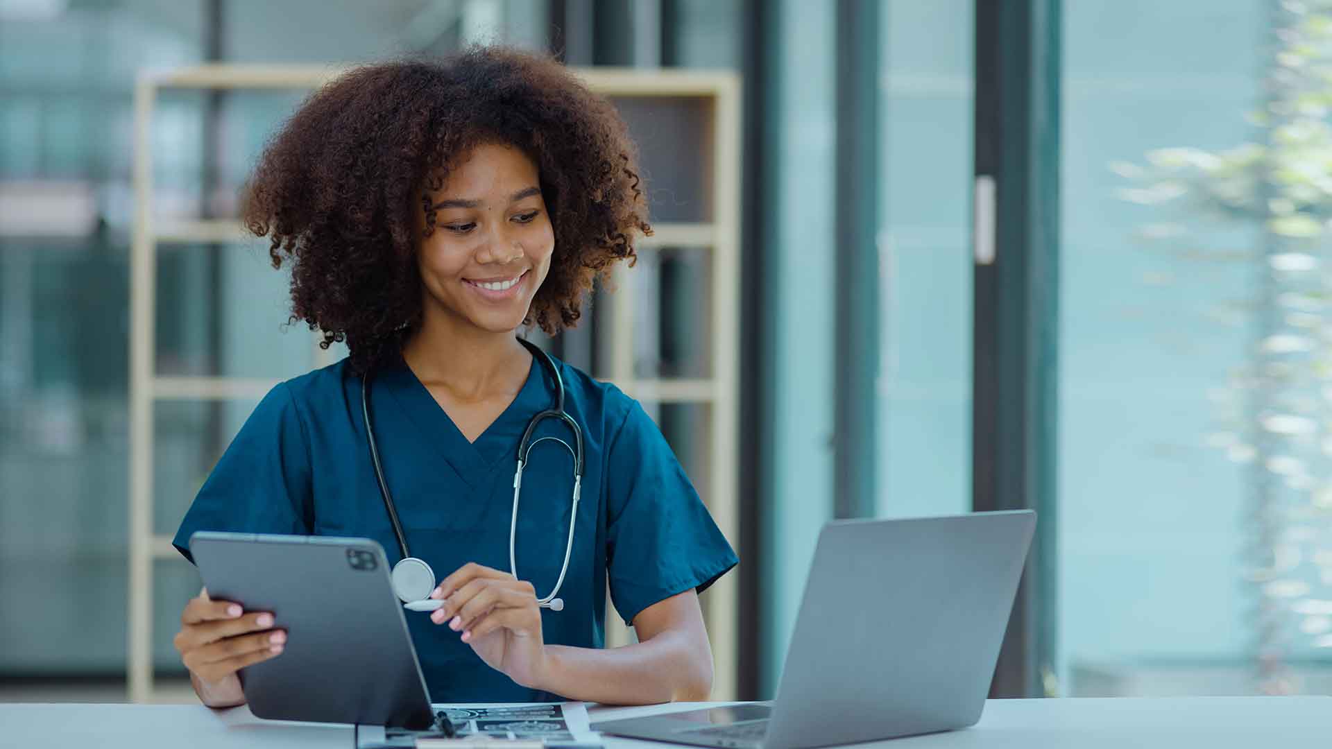health information management technician transfers patient info to laptop