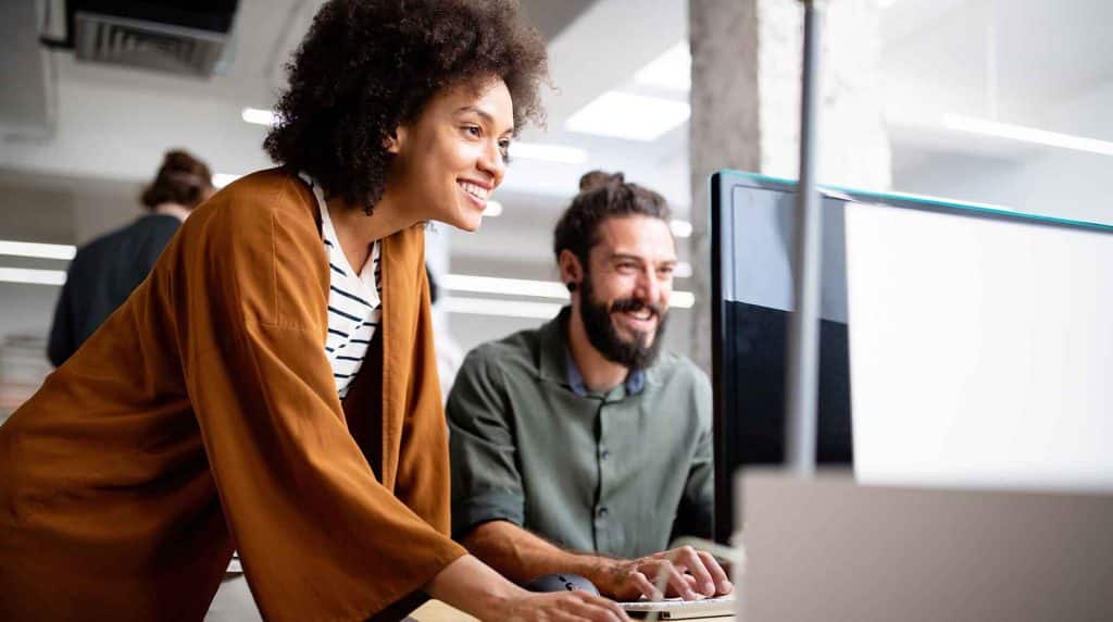 marketing professionals review digital campaign on computer