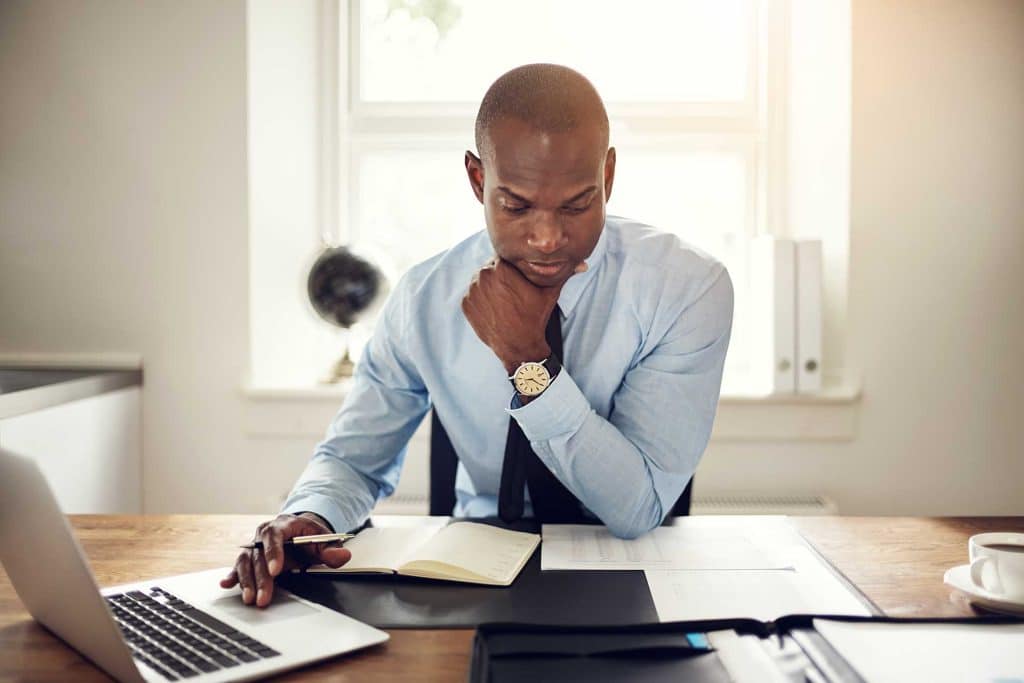 accountant reviews data for client project on laptop