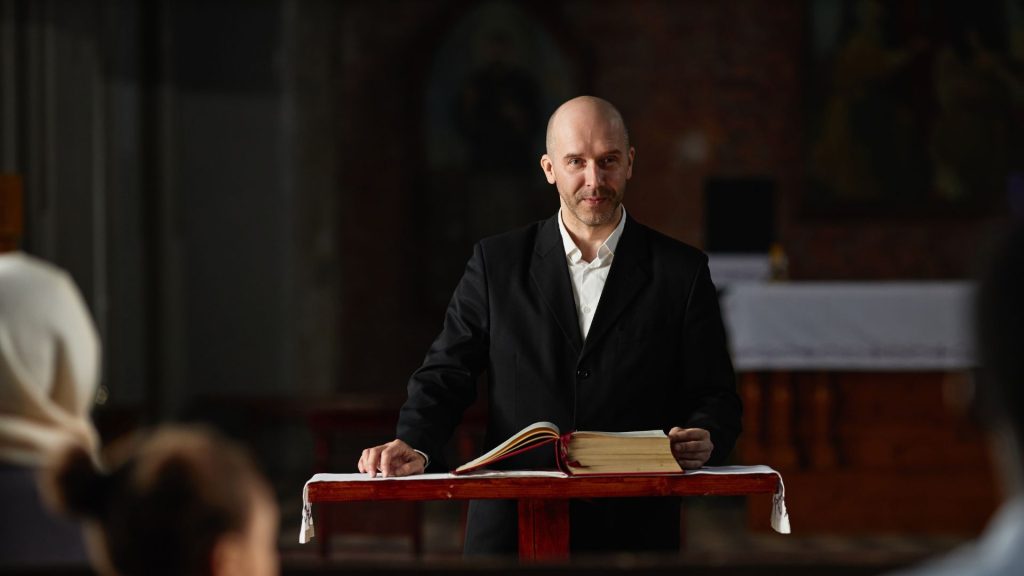 a pastor delivers a sermon to his congregation